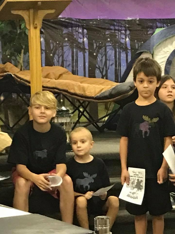Children in matching shirts at a church program